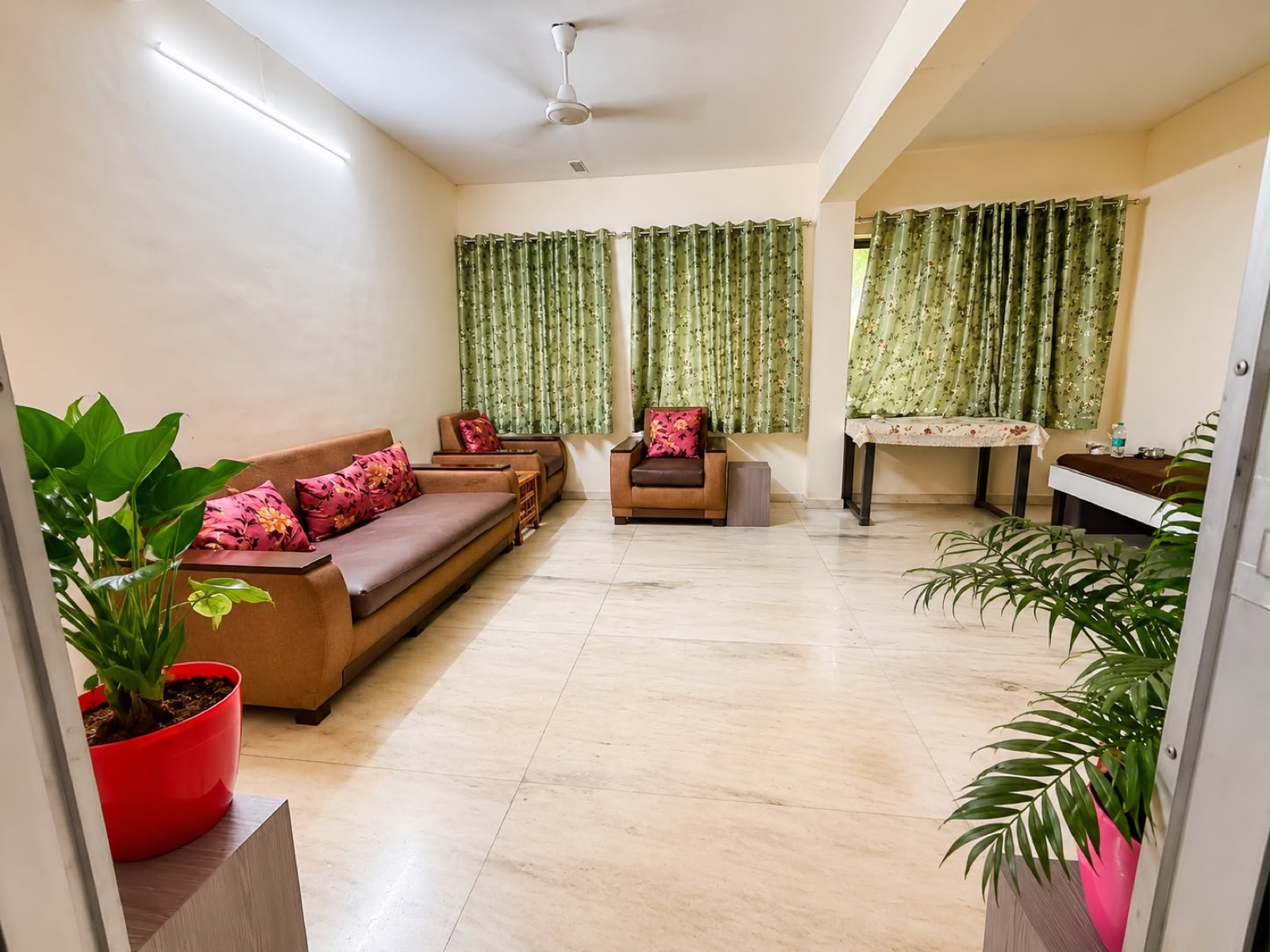 Living room with sofas and green curtains